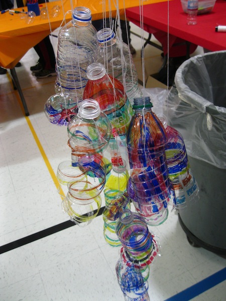 The process continues: cut the bottles with scissors to create the curls of plastic, reminiscent of Chihuly's blown glass.